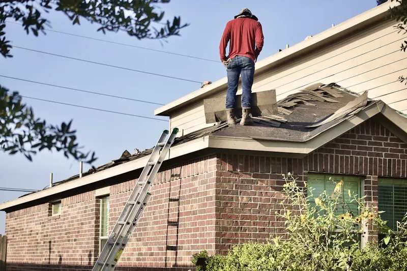 Professional roofer working on a residential roof in Marlton Lakes
